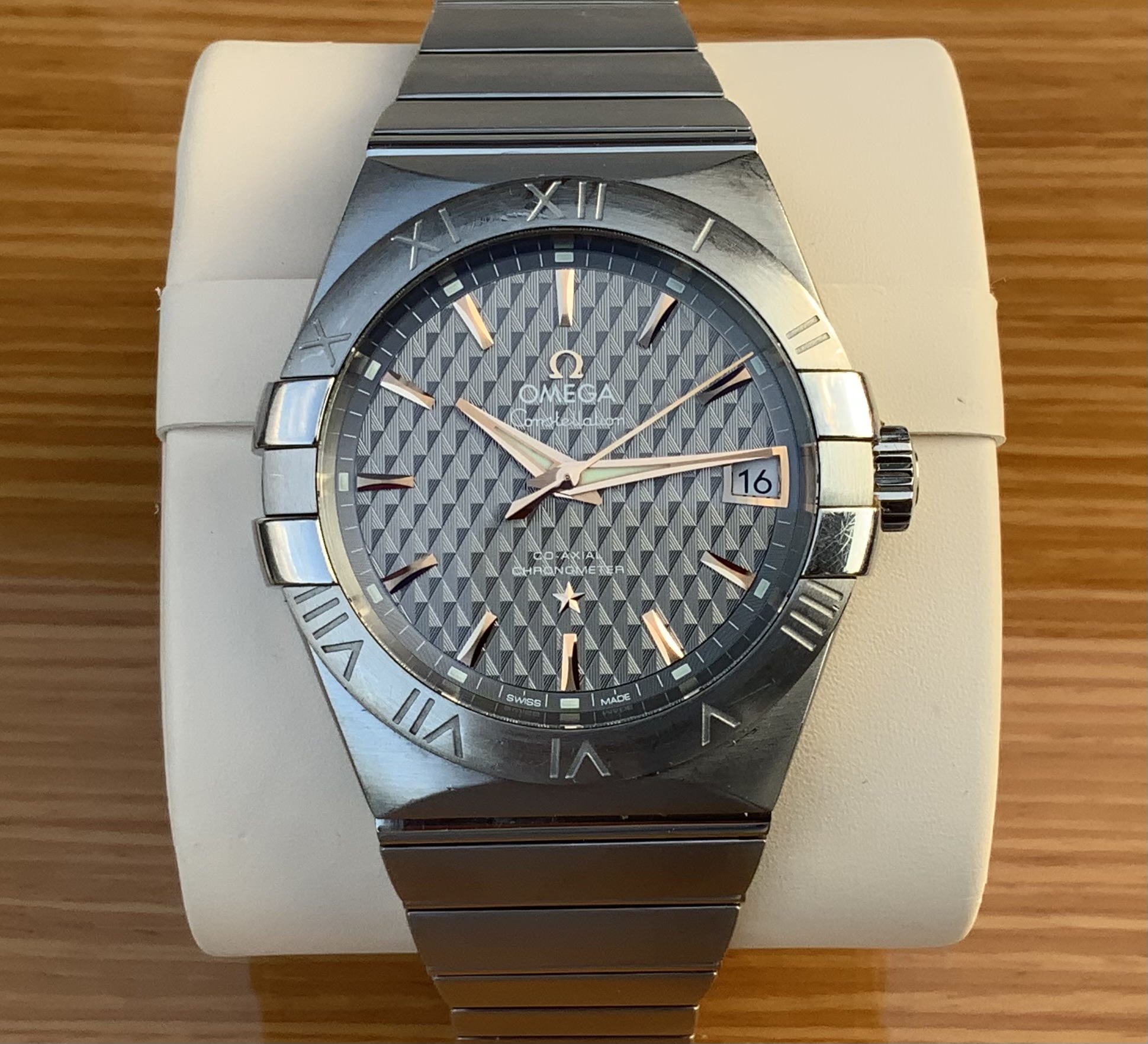 Omega Constellation Co-Axial Chronometer, frontal view on white Omega cushion