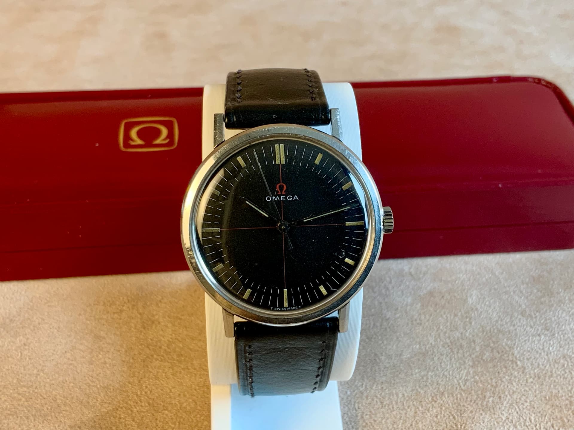 Vintage Omega manual wind dress watch with black dial on black leather strap