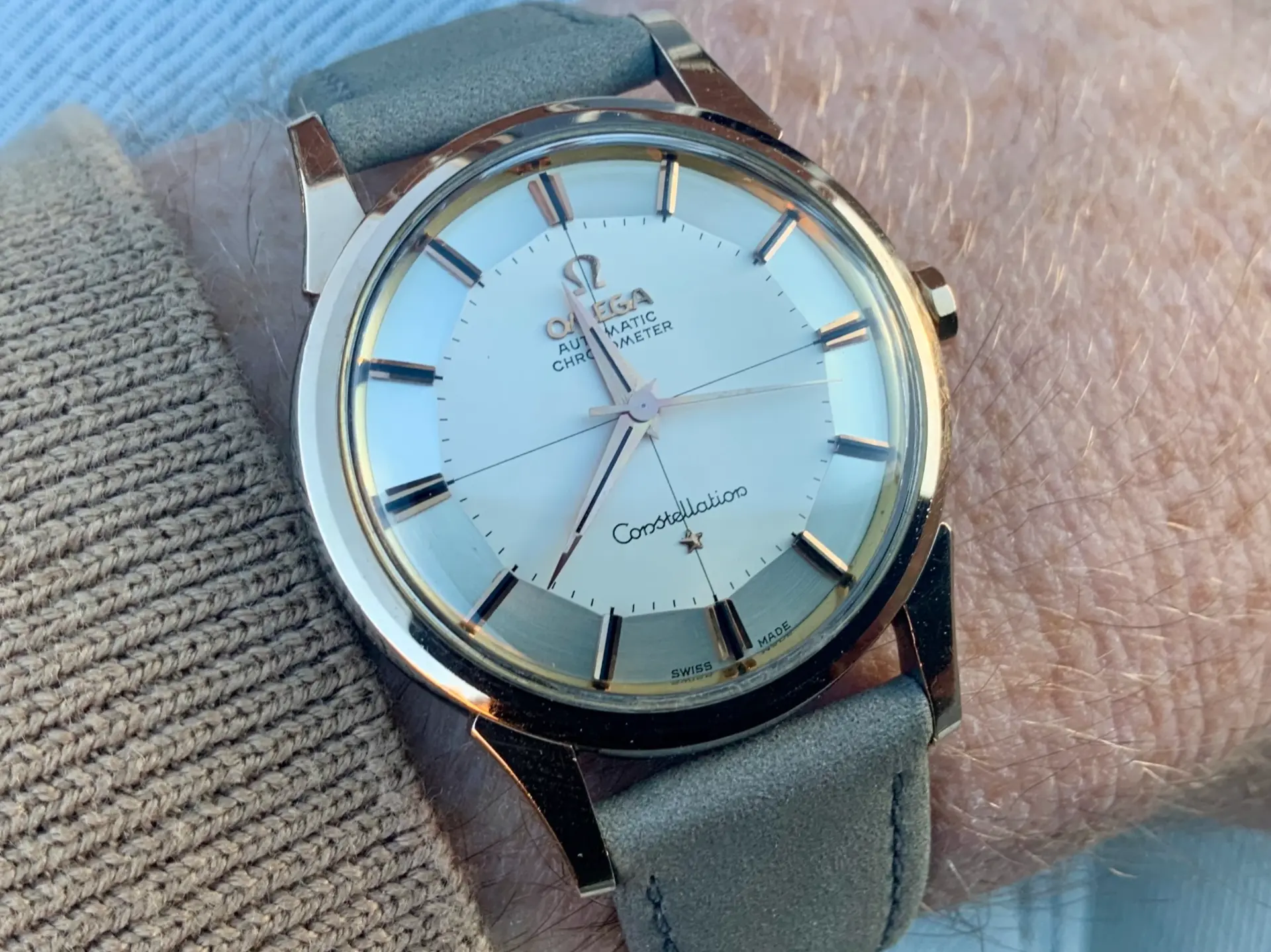Omega Constellation pie-pan chronometer on grey suede strap worn on wrist