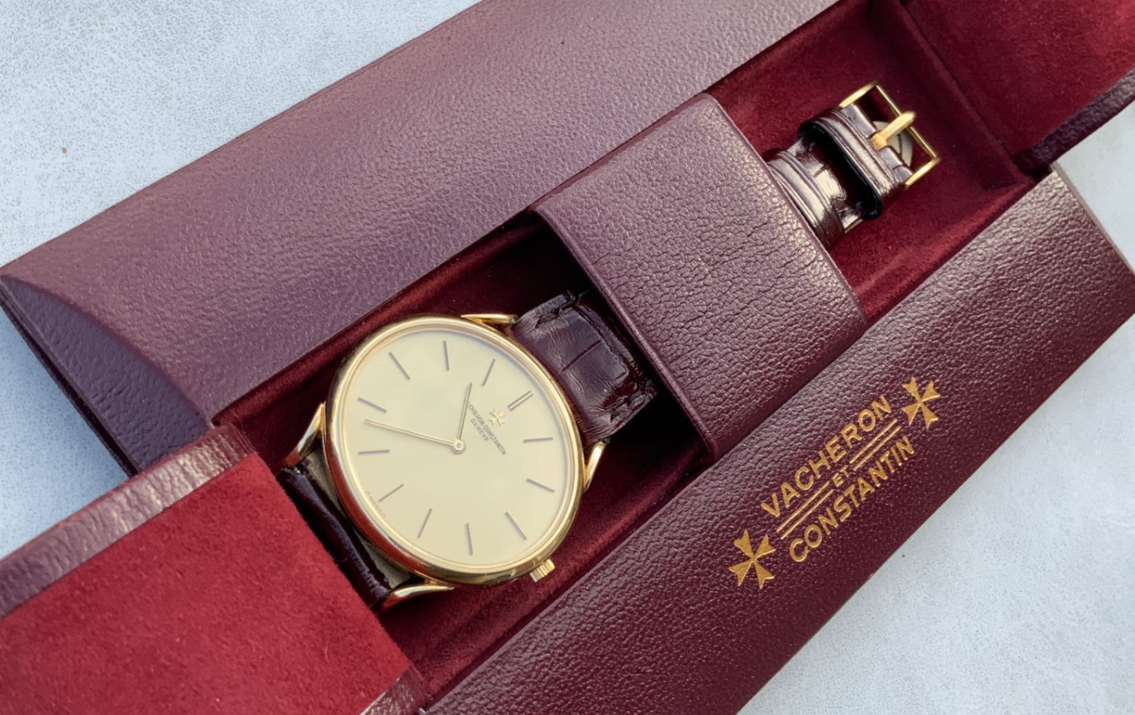 A Vacheron Constantin dress watch resting in its burgundy presentation box