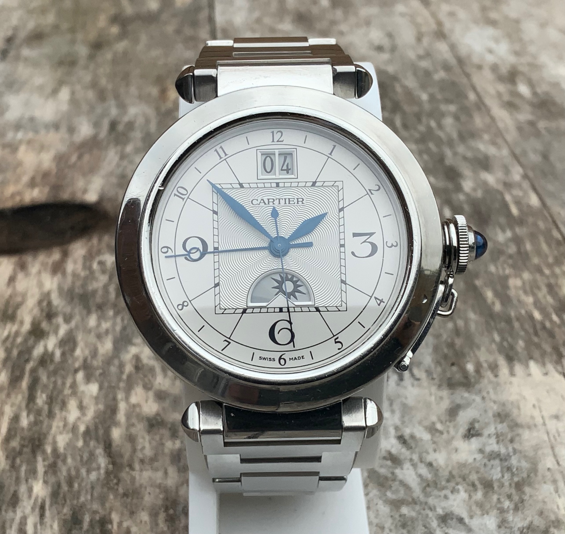 Cartier Pasha Day & Night GMT, frontal view on wooden surface