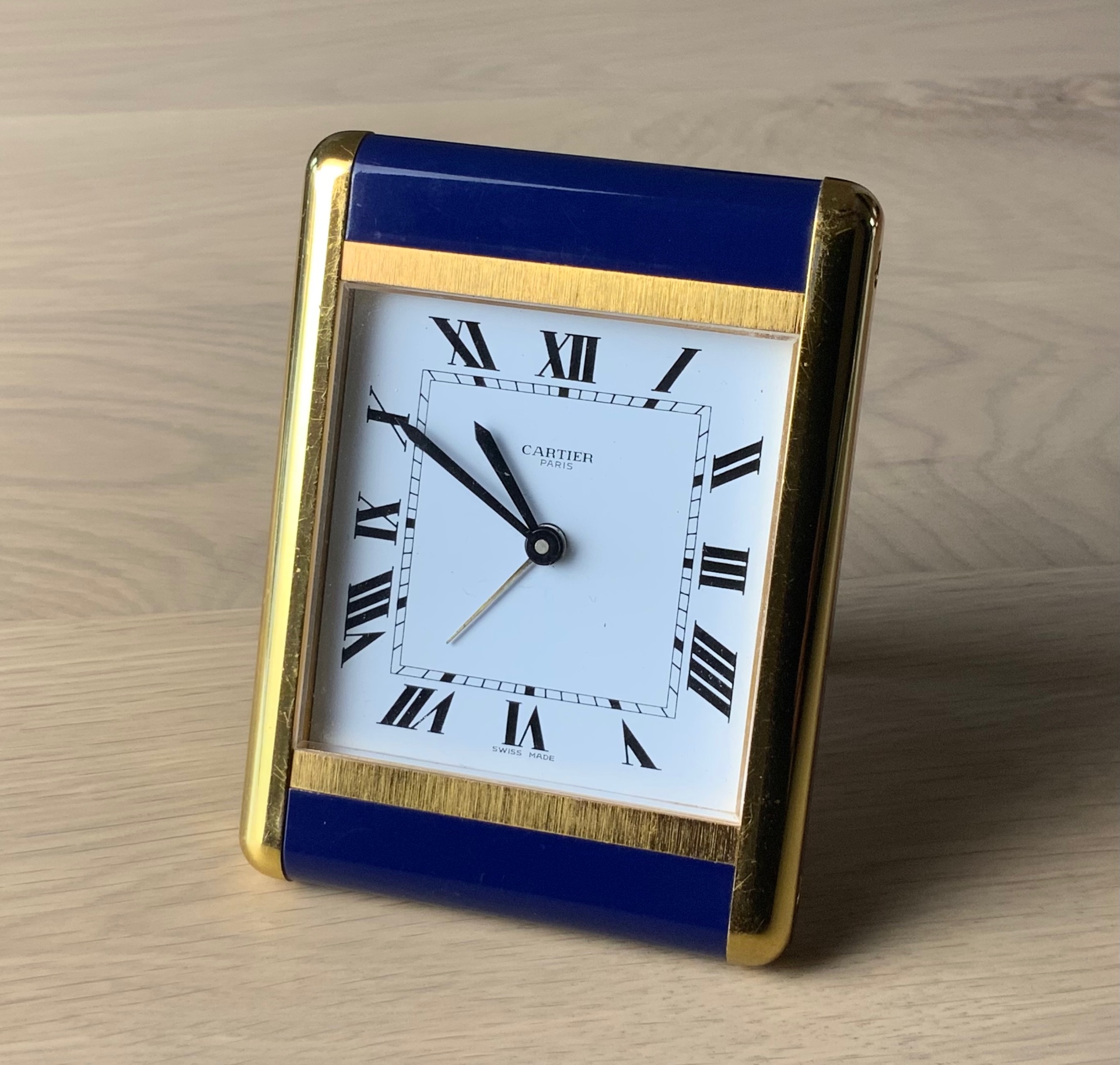Cartier Tank Travel Alarm Clock Ref. 7505 shown frontally within its open red Cartier presentation box